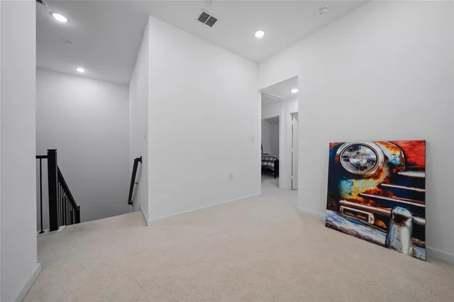 a view of an empty room and wooden floor