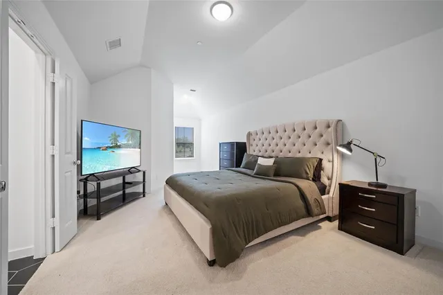 a bed room with a bed and a television