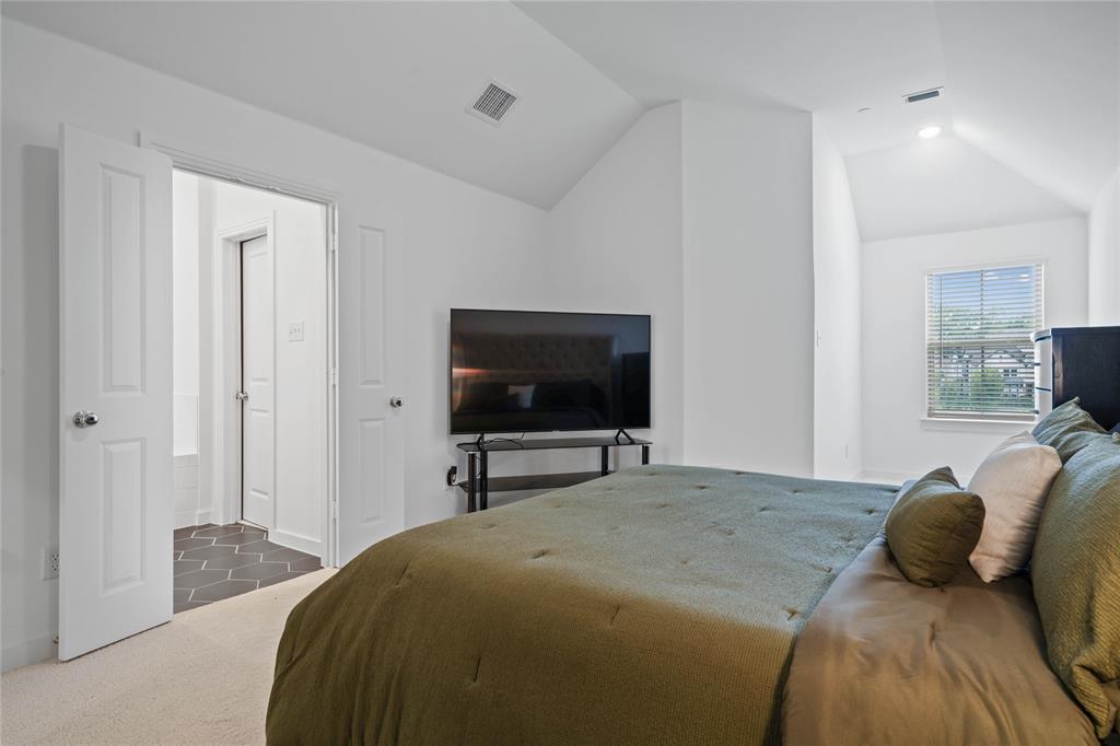 313 Sugar Maple Lane McKinney, TX 75071 - Photo 24 of 40 a bedroom with a bed and a flat screen tv