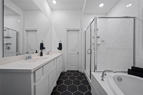 a bathroom with a double vanity sink and mirror