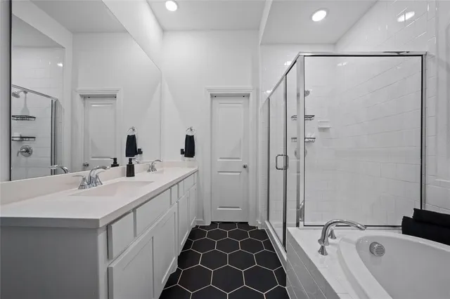 a bathroom with a double vanity sink and mirror
