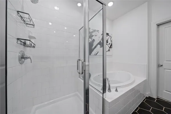 a bathroom with a bathtub and shower