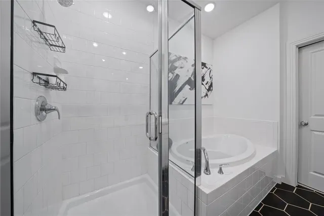 a bathroom with a bathtub and shower