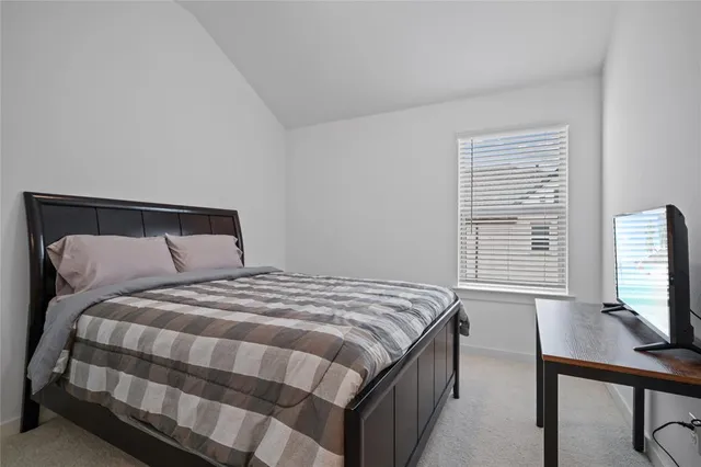 a bedroom with a bed a desk and chair