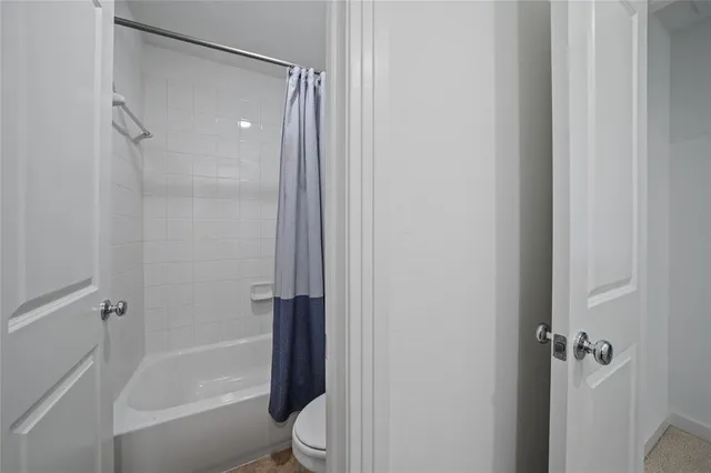 a bathroom with a bathtub shower sink vanity and toilet