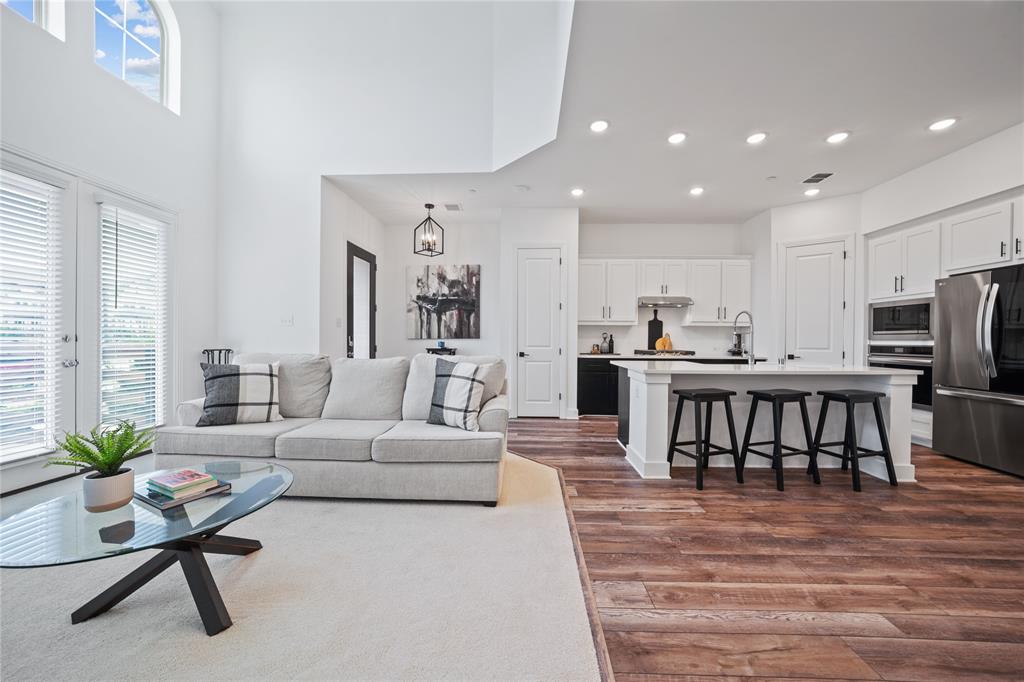 313 Sugar Maple Lane McKinney, TX 75071 - Photo 7 of 40 a living room with furniture and a dining table with kitchen view