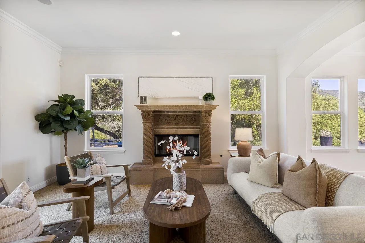 20919 Questhaven Road San Marcos, CA 92078 - Photo 12 of 54 a living room with furniture a chandelier and a fireplace