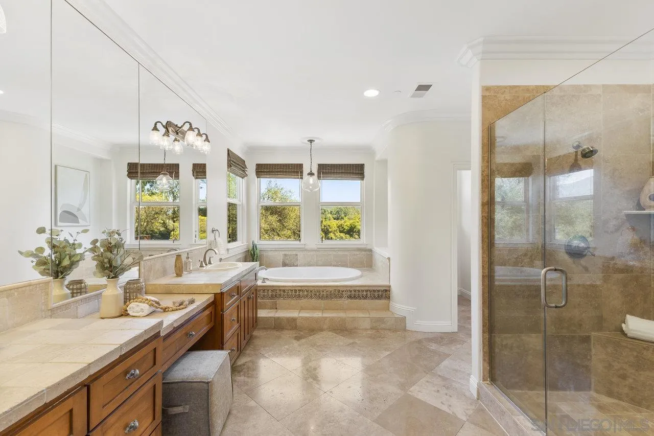 20919 Questhaven Road San Marcos, CA 92078 - Photo 28 of 54 a spacious bathroom with a granite countertop tub sink and mirror