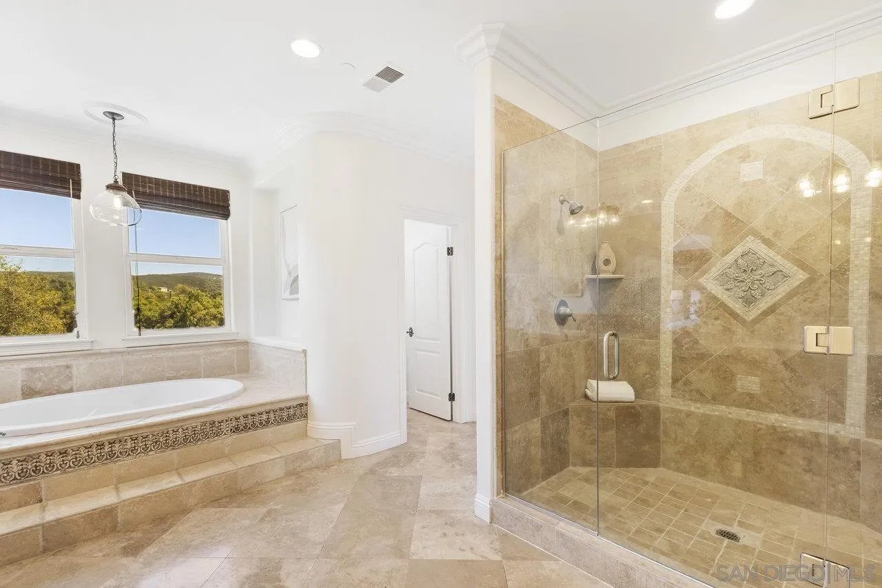 20919 Questhaven Road San Marcos, CA 92078 - Photo 29 of 54 a bathroom with a shower and a bathtub