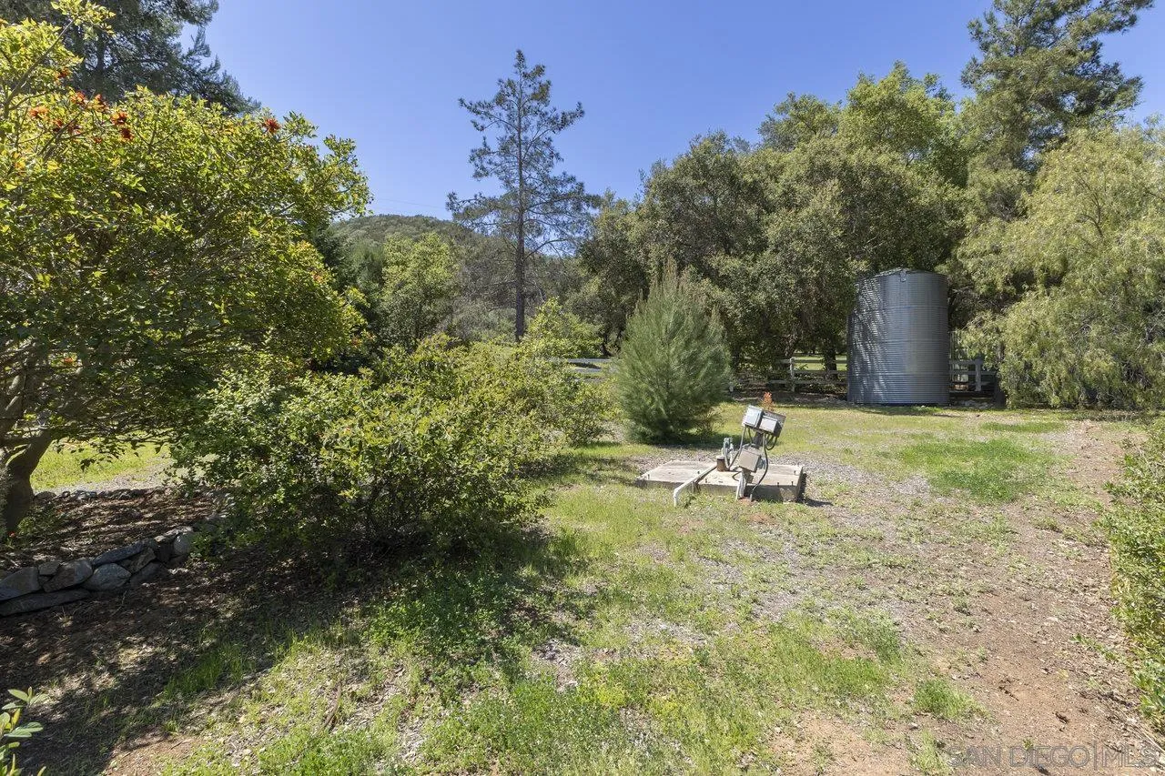 20919 Questhaven Road San Marcos, CA 92078 - Photo 45 of 54 a white bench sitting in the middle of a yard