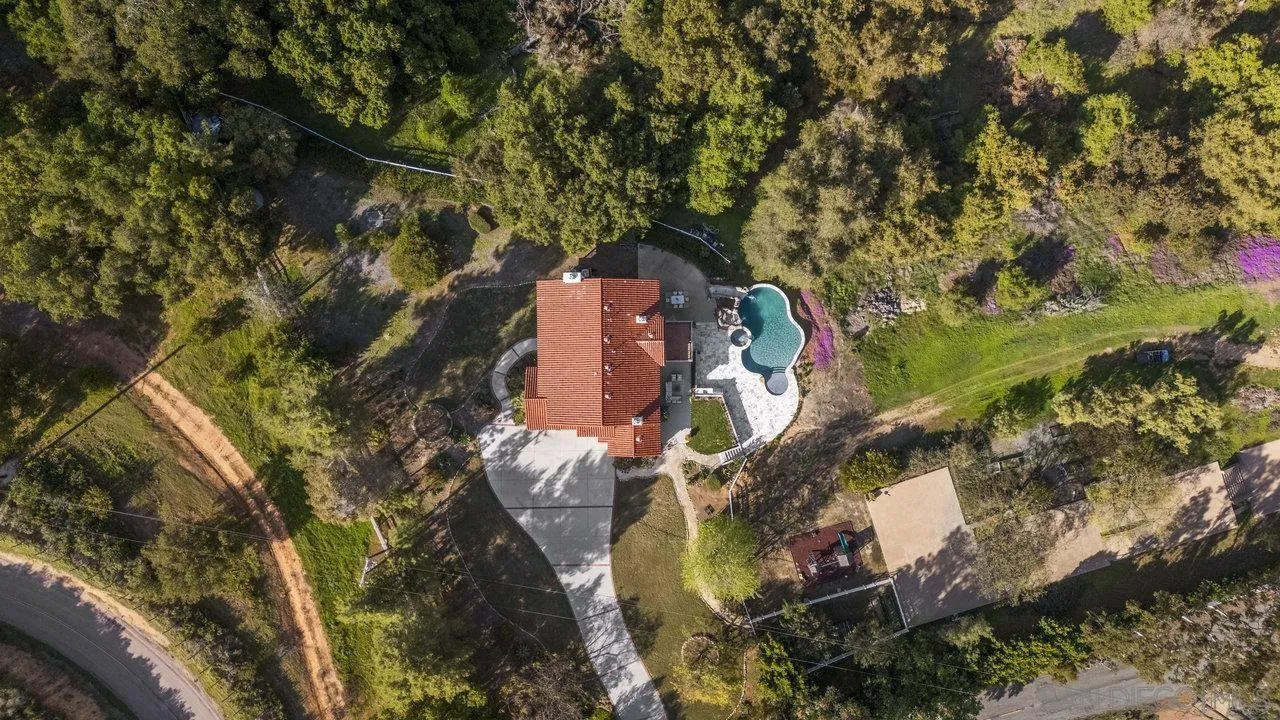 20919 Questhaven Road San Marcos, CA 92078 - Photo 46 of 54 an aerial view of a house with a yard and large trees