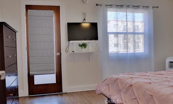 a bedroom with a bed and a flat screen tv
