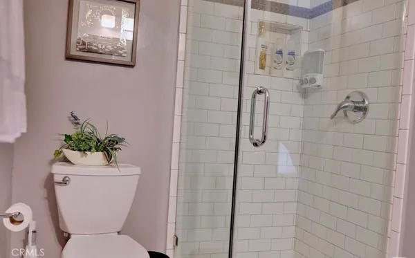 a bathroom with a toilet sink and shower