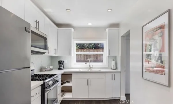 a kitchen with stainless steel appliances granite countertop a stove and a sink