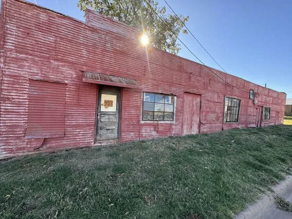 a view of a brick house with a yard