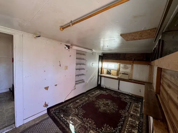 a room with lot of frames on wall and a window