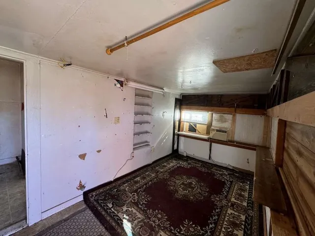 a room with lot of frames on wall and a window