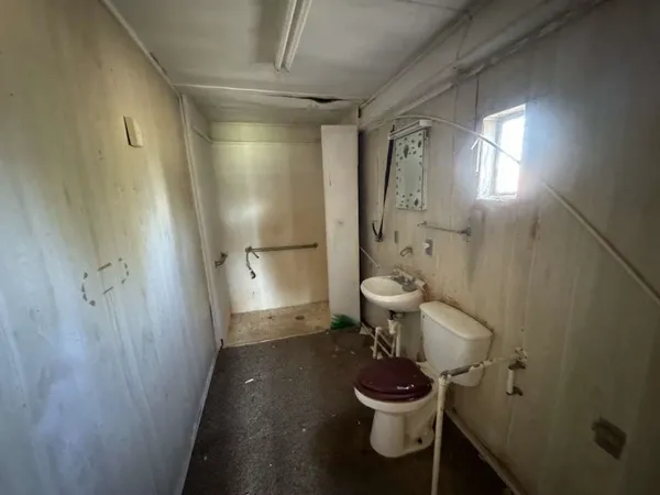 a bathroom with a toilet and a shower