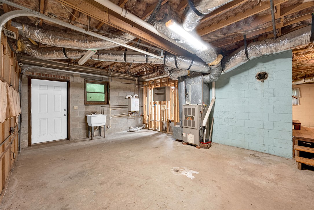 237 Spring Valley Road Liberty, SC 29657 - Photo 23 of 50 A spacious, unfinished basement offers versatile storage or future expansion opportunities.