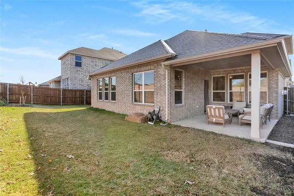 a view of a house with backyard porch and sitting area