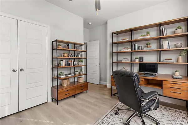 a view of a workspace with furniture and cabinet