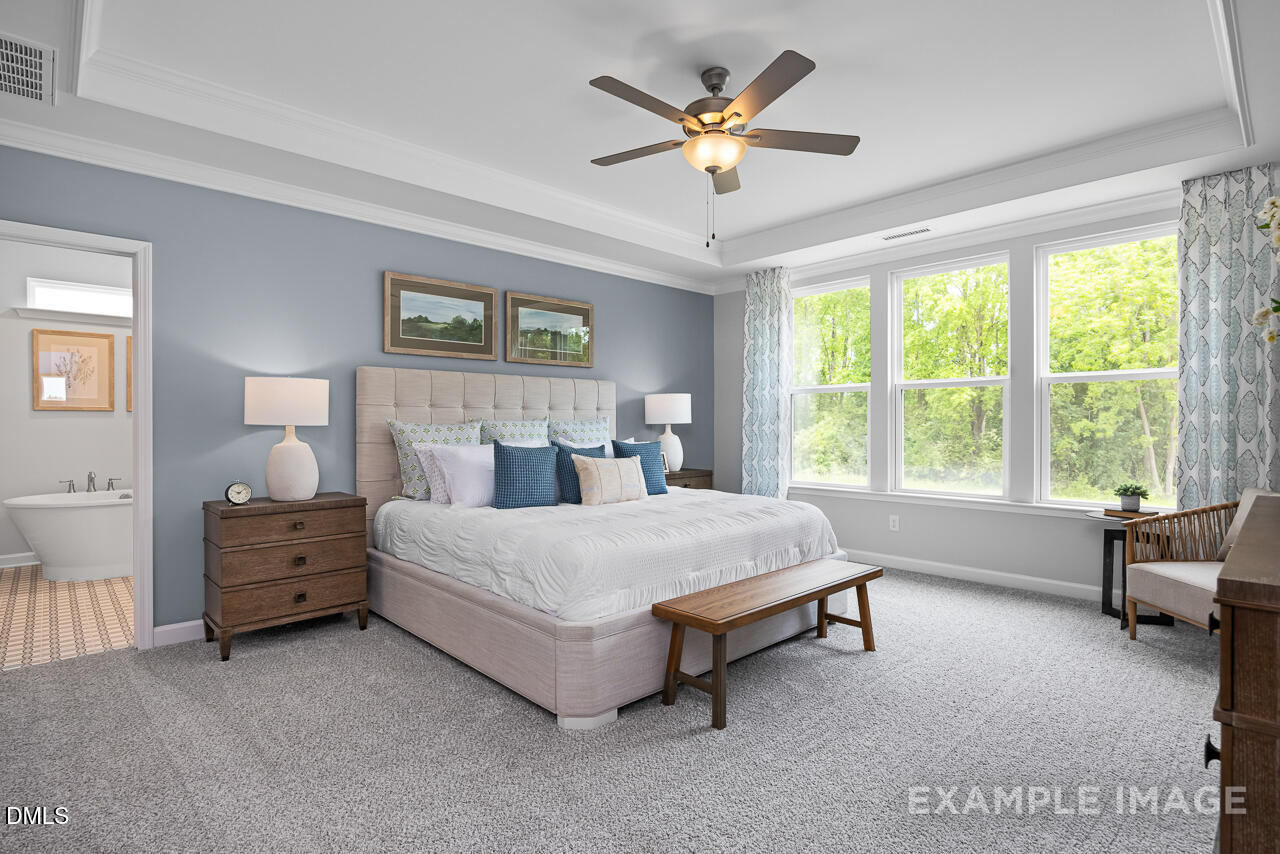 185 Crop Road Angier, NC 27501 - Photo 15 of 33 a spacious bedroom with a bed and a large window