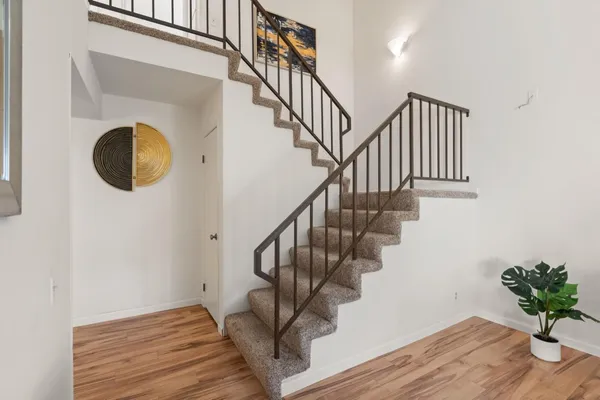 a view of entryway and hall with wooden floor