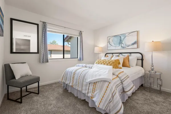 a bedroom with a bed and window