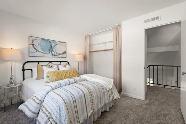 a bedroom with a bed and lamp