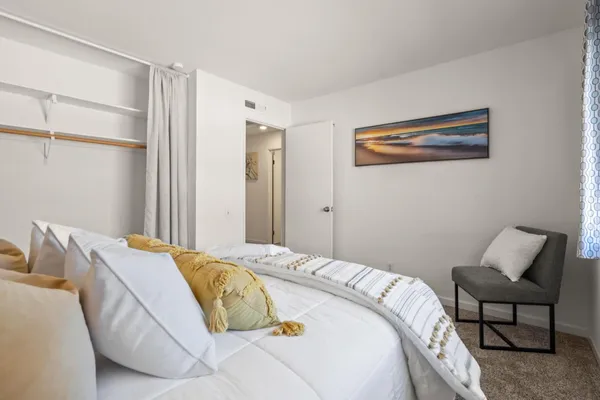 a bedroom with a bed and chair