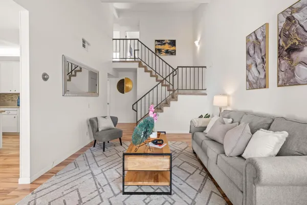 a living room with furniture and stairs