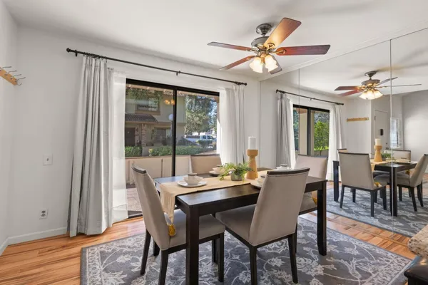 a view of a dining room with furniture window and wooden floor