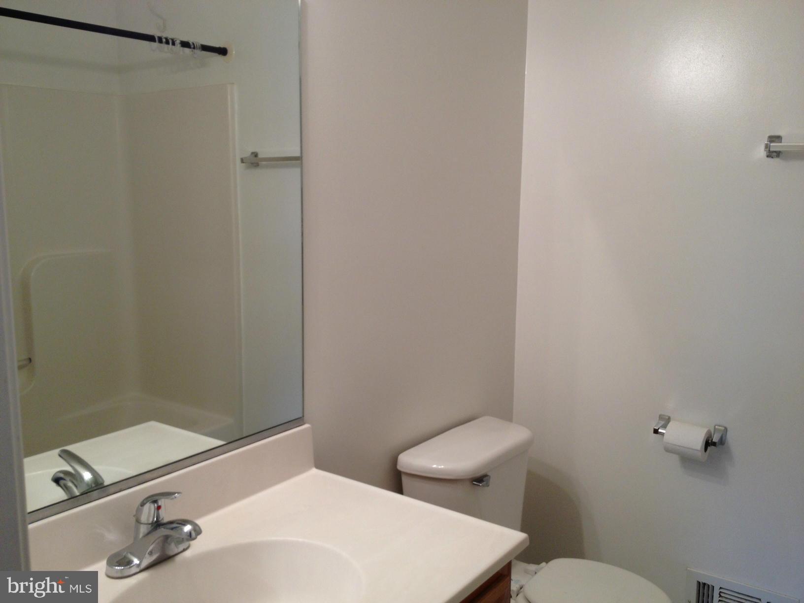412 East 10th Avenue Ranson, WV 25438 - Photo 15 of 27 a bathroom with a sink a toilet and shower