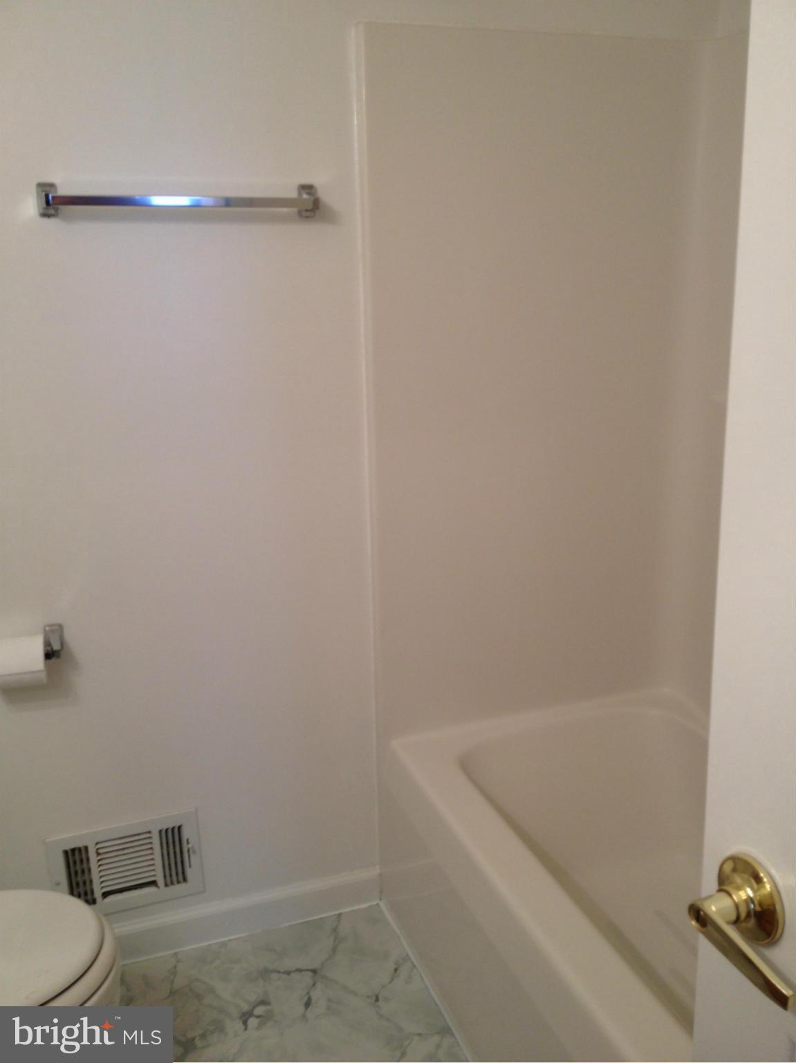 412 East 10th Avenue Ranson, WV 25438 - Photo 16 of 27 a bathroom with a bathtub