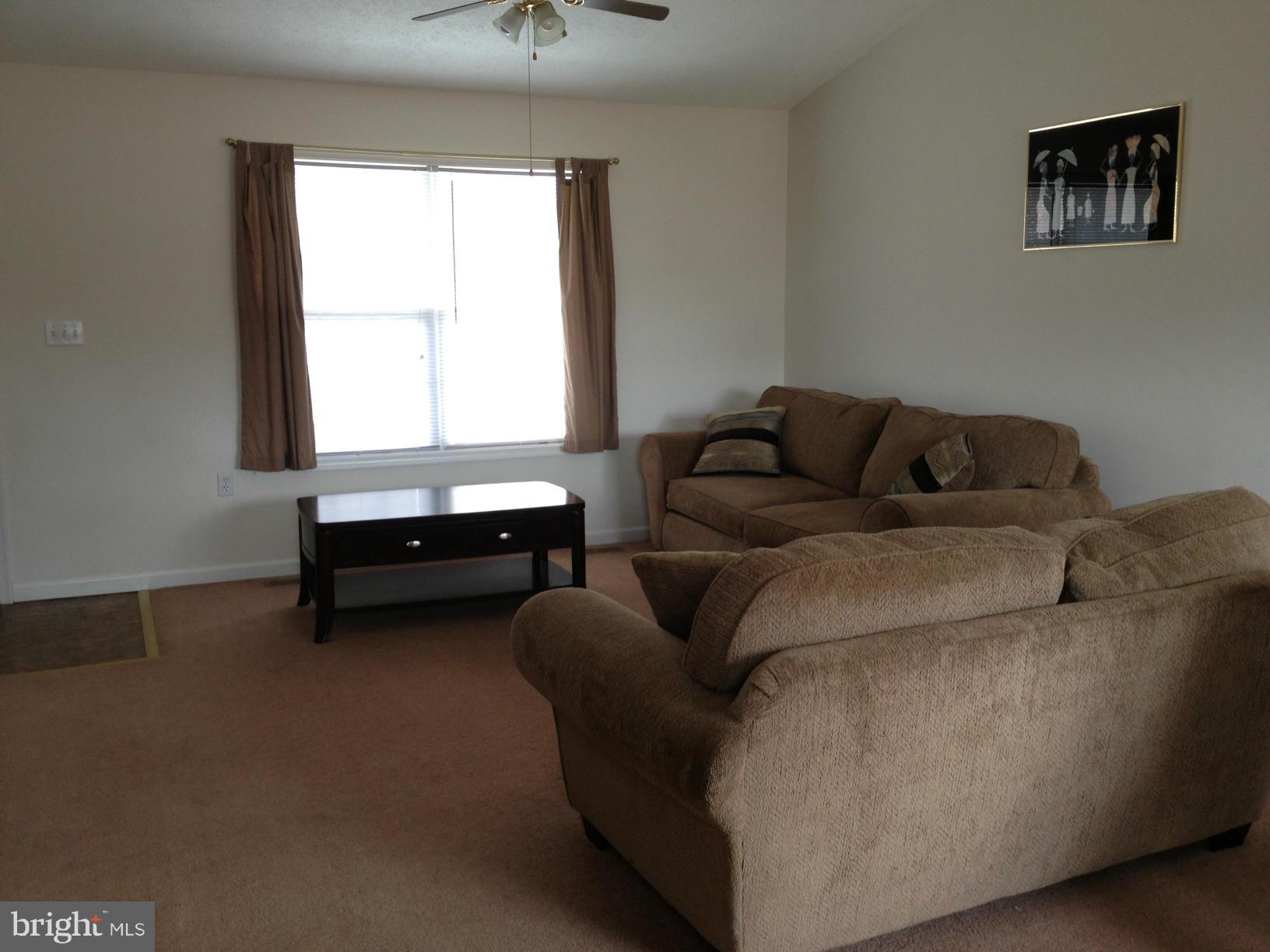 412 East 10th Avenue Ranson, WV 25438 - Photo 7 of 27 a living room with furniture and a window