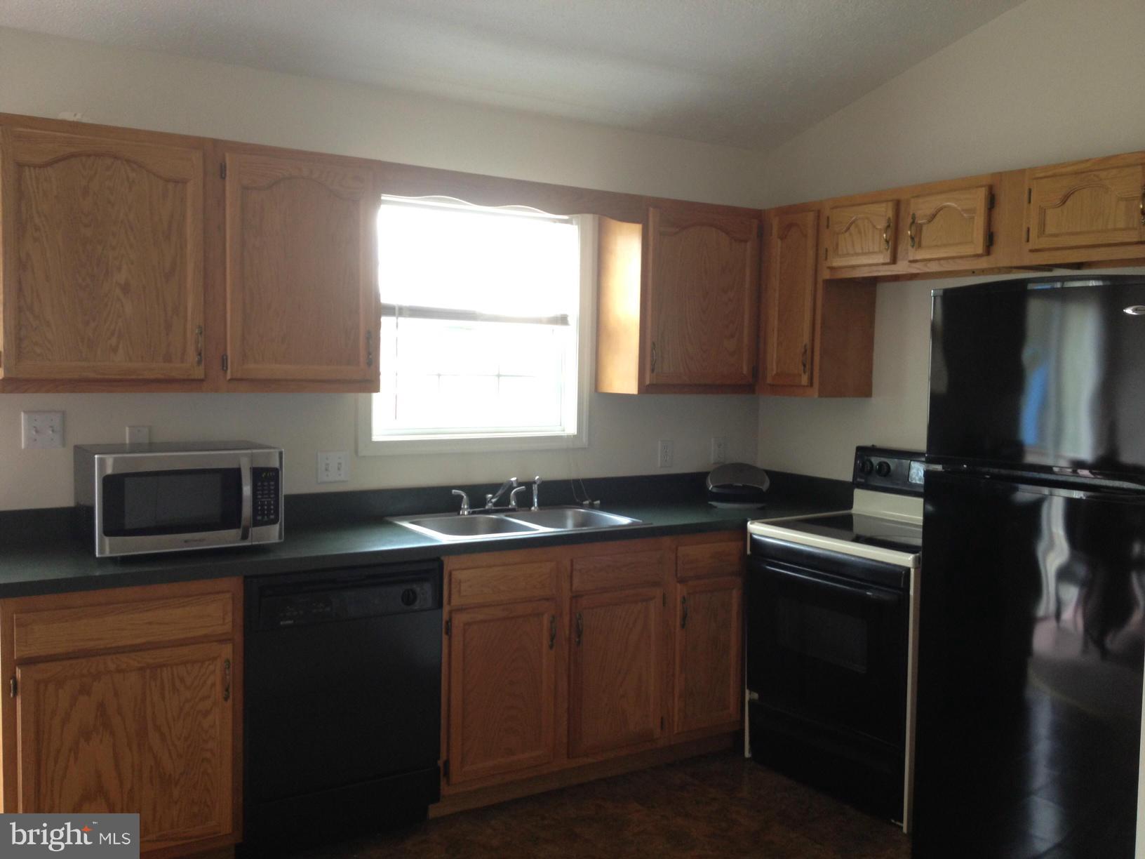 412 East 10th Avenue Ranson, WV 25438 - Photo 10 of 27 a kitchen with a sink stove and refrigerator