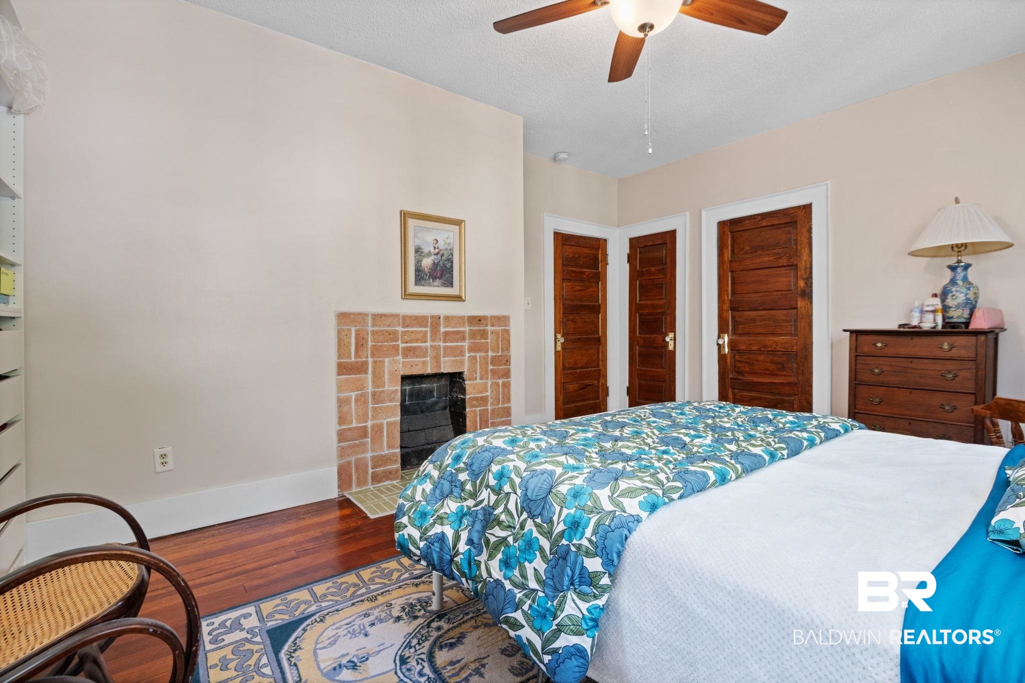 324 4th Street Mobile, AL 36611 - Photo 22 of 28 Bedroom with hardwood / wood-style flooring, a fireplace, multiple closets, and ceiling fan