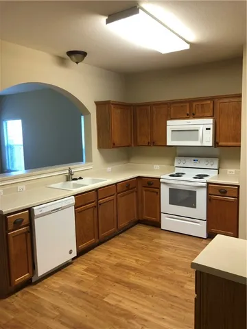 a kitchen with stainless steel appliances granite countertop a stove and a sink