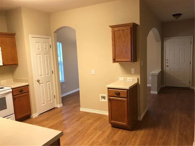 a kitchen with stainless steel appliances granite countertop a refrigerator and a stove top oven