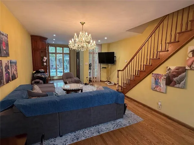 a living room with furniture and a chandelier