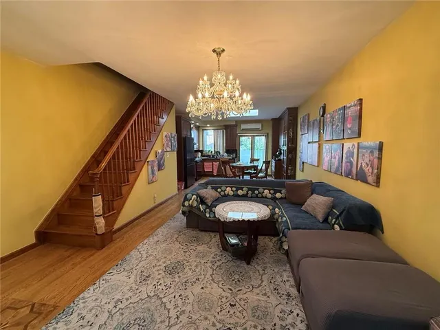 a living room with furniture and a chandelier