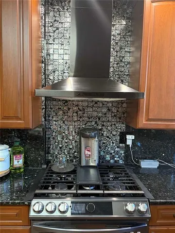 a kitchen with a stove and cabinets