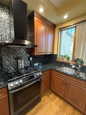 a kitchen with a sink stove and cabinets