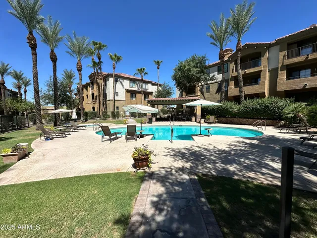 a view of a house with a yard and sitting area