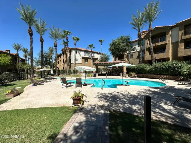 a living room with furniture a fireplace and a chandelier