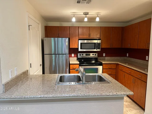 a kitchen with appliances and cabinets