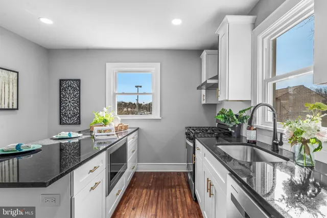 a kitchen with sink refrigerator and window