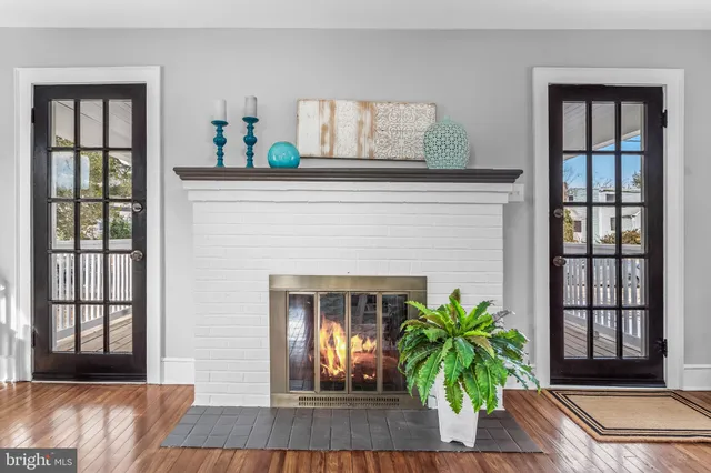 a living room with furniture a chandelier and a rug