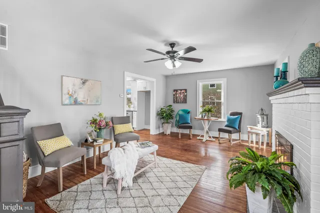 a dining room with furniture potted plants and wooden floor