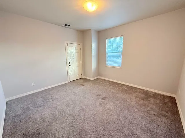 an empty room with windows and closet
